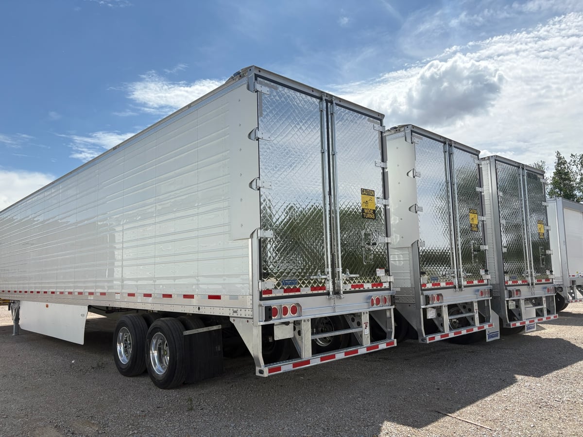 Row of finished Vanguard refrigerated trailers in the Monon plant yard