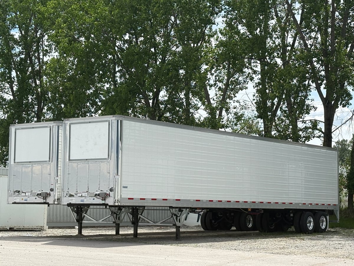 Two finished Vanguard refrigerated trailers parked in the plant yard