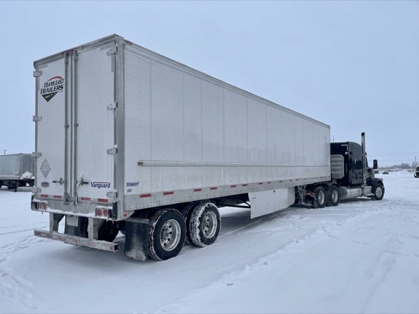 Vanguard reefer trailer leading in deep snow with salt spray on the lower body