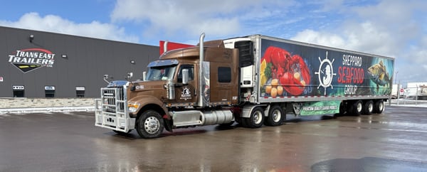 Sheppard Seafood-wrapped Vanguard refrigerated trailer hauled by a tractor