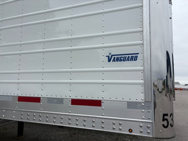 Side profile of a Vanguard reefer showing the tall 12-inch base rail along the lower side wall