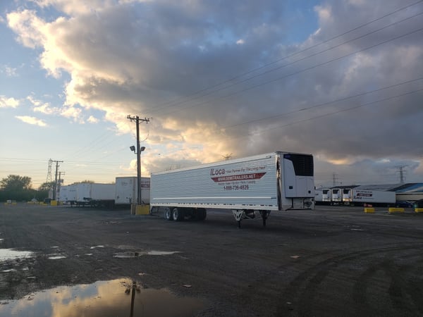 A Vanguard reefer trailer in a customer fleet yard at golden hour under a dramatic sky